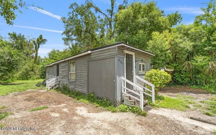 3131 Dignan Street Jacksonville, FL 32254 - Photo 3 of 16 a backyard of a house with plants and tree