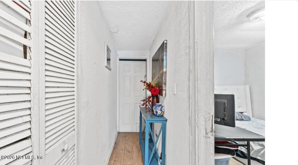 3131 Dignan Street Jacksonville, FL 32254 - Photo 4 of 16 a view of a hallway with wooden floor and windows