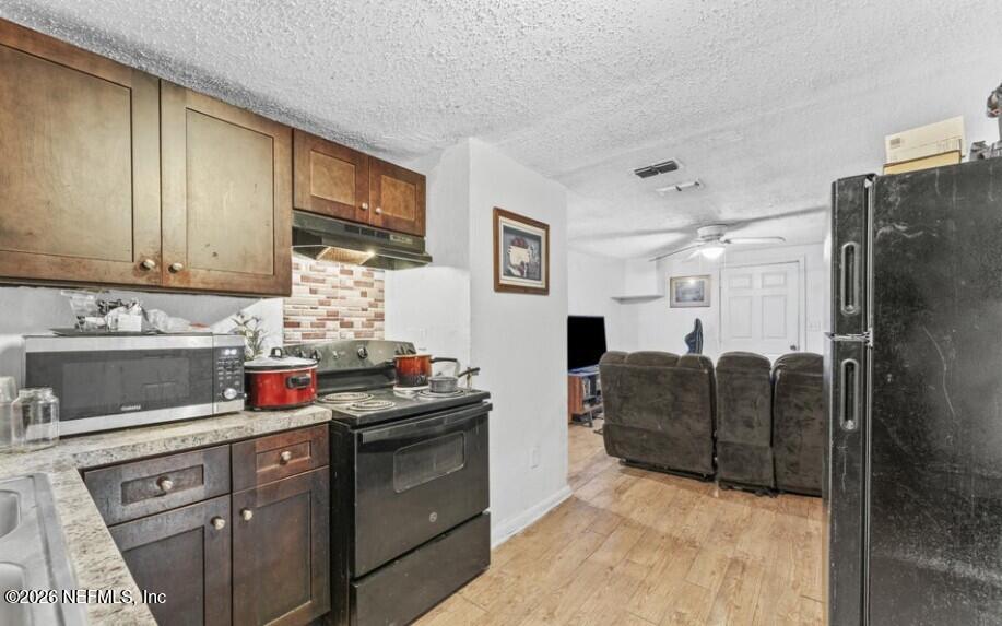 3131 Dignan Street Jacksonville, FL 32254 - Photo 7 of 16 a kitchen with stainless steel appliances granite countertop a refrigerator and cabinets