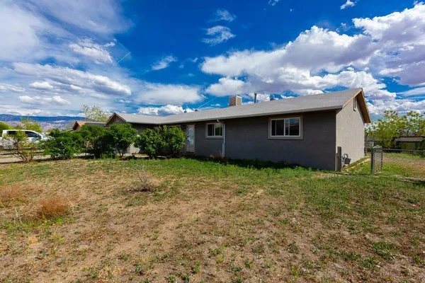 a view of a house with a backyard