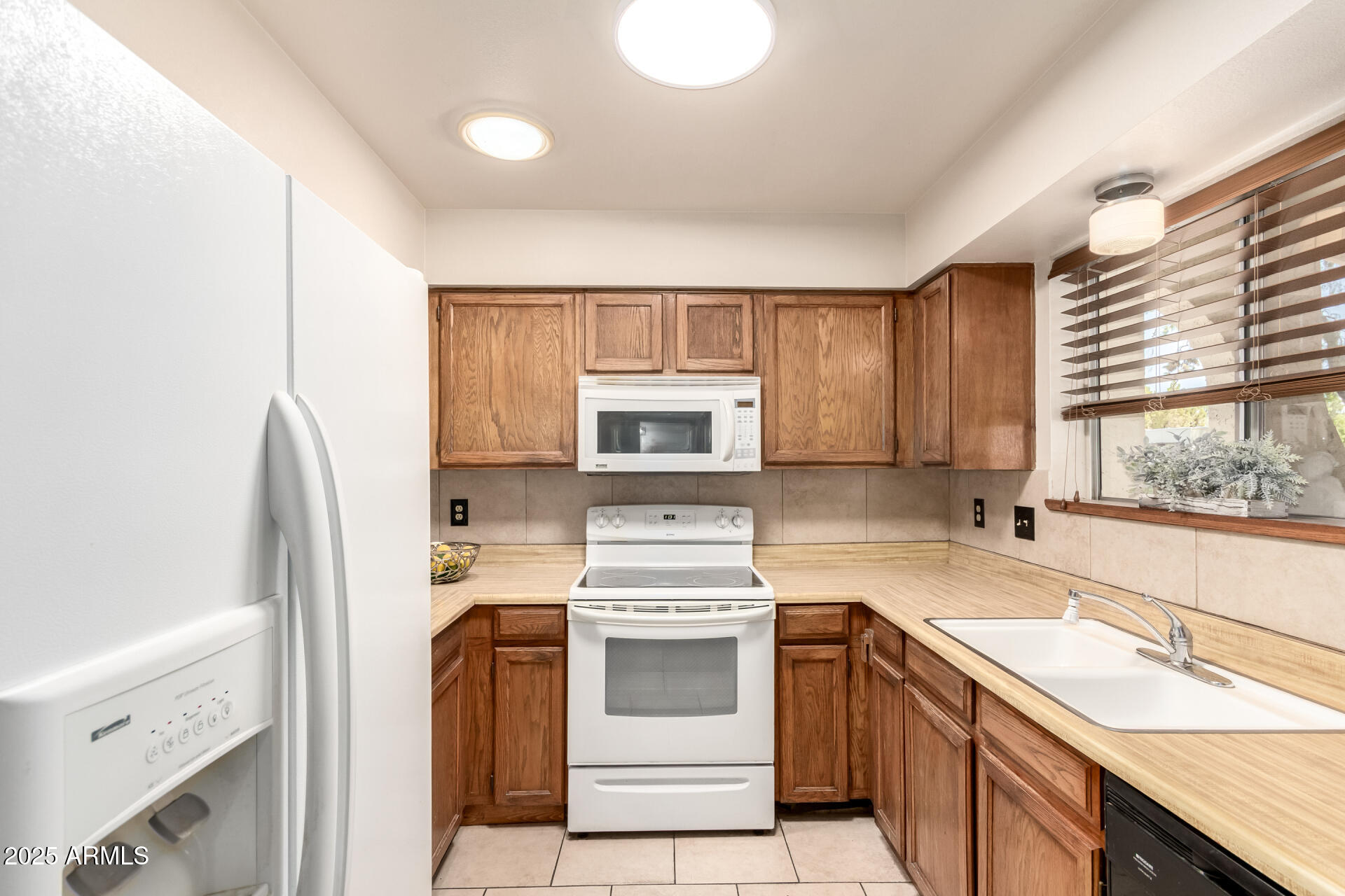 131 North Higley Road, Unit 1 Mesa, AZ 85205 - Photo 14 of 32 a kitchen with a stove a sink and a refrigerator