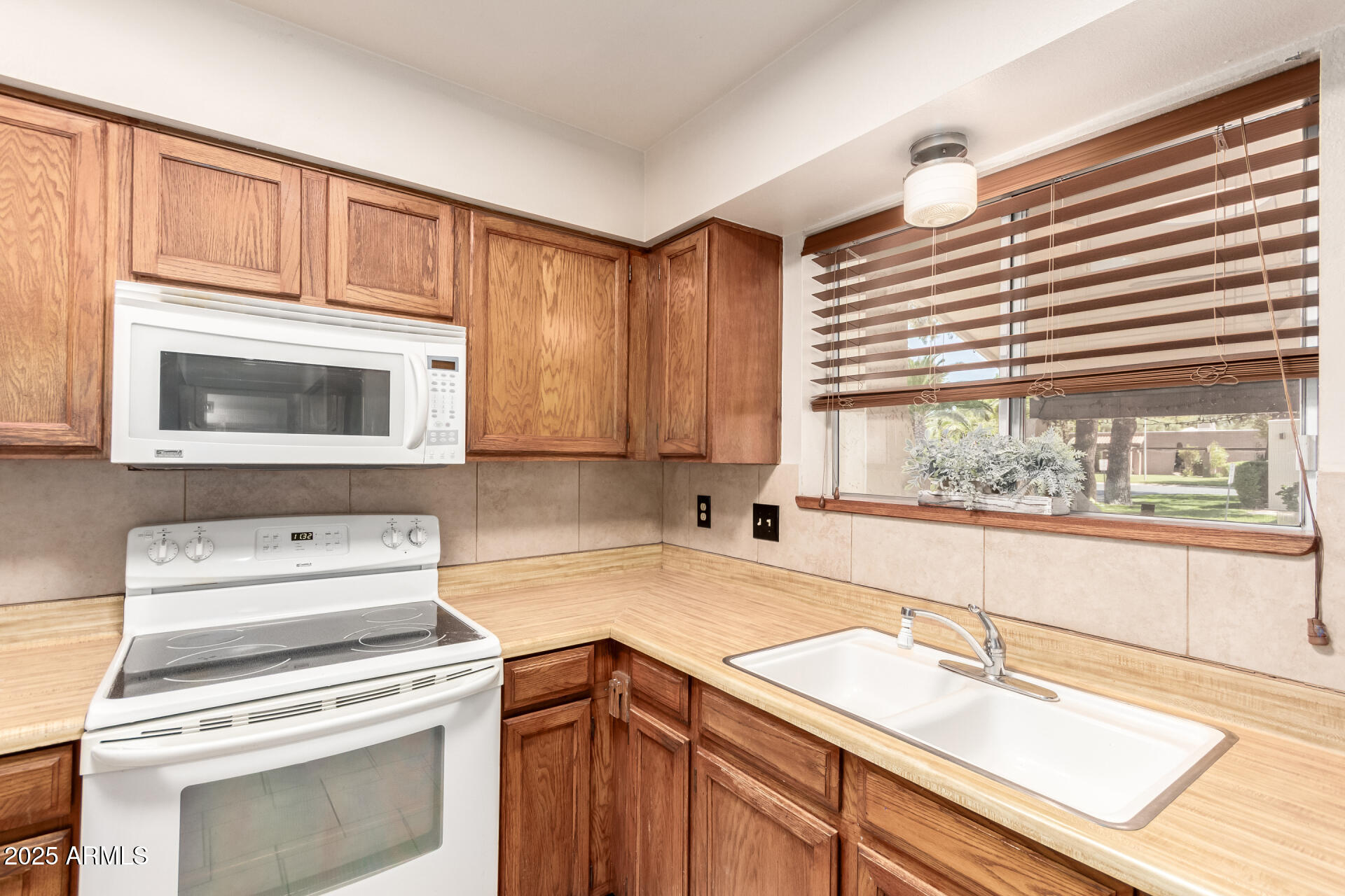 131 North Higley Road, Unit 1 Mesa, AZ 85205 - Photo 15 of 32 a kitchen with a stove and a sink