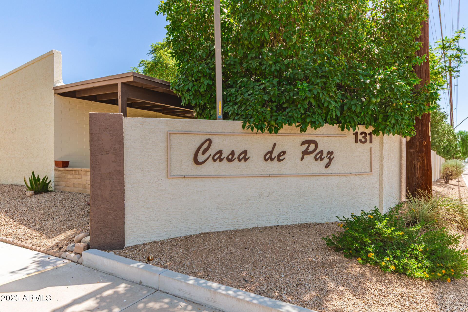 131 North Higley Road, Unit 1 Mesa, AZ 85205 - Photo 25 of 32 a view of outdoor space with signage and flags