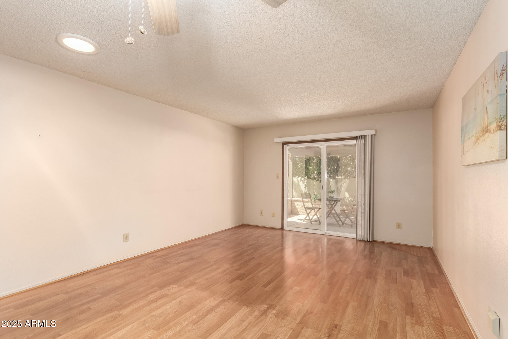 131 North Higley Road, Unit 1 Mesa, AZ 85205 - Photo 9 of 32 an empty room with wooden floor and windows