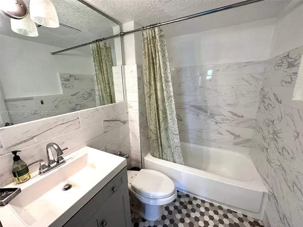 a bathroom with a sink mirror toilet and bathtub