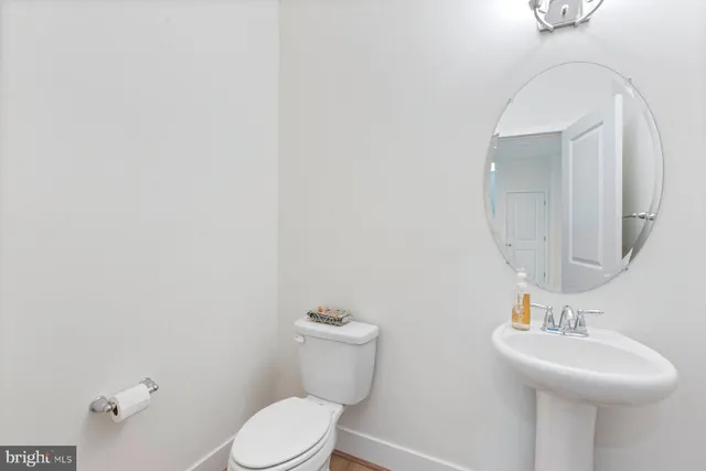 a view of a livingroom with wooden floor fireplace and windows