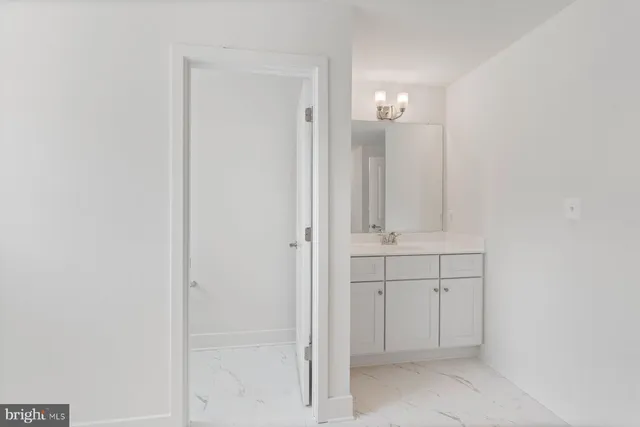 a bathroom with a shower sink and mirror