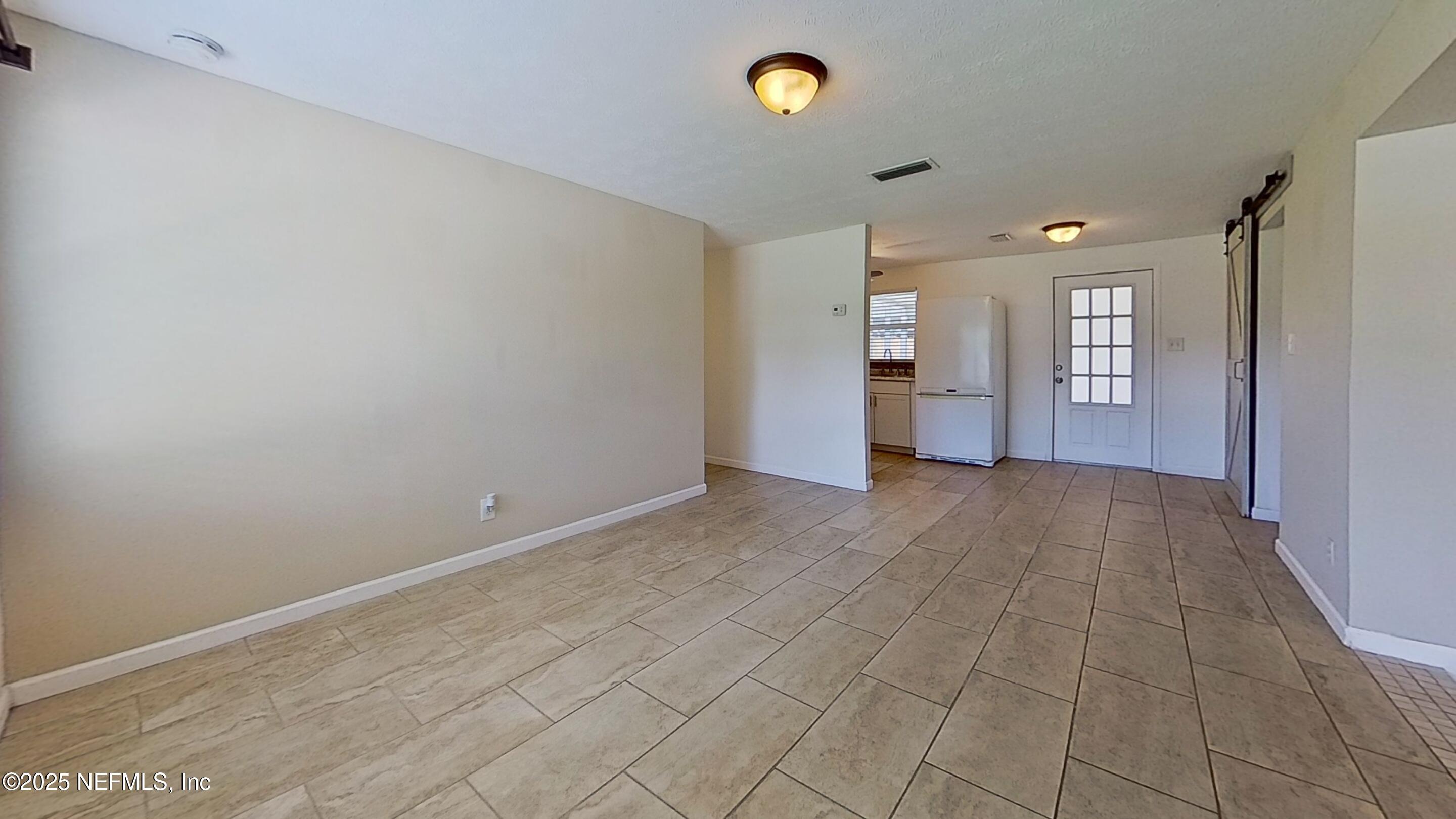 399 Toccoa Road Orange Park, FL 32073 - Photo 13 of 31 a view of a big room with wooden floor and windows
