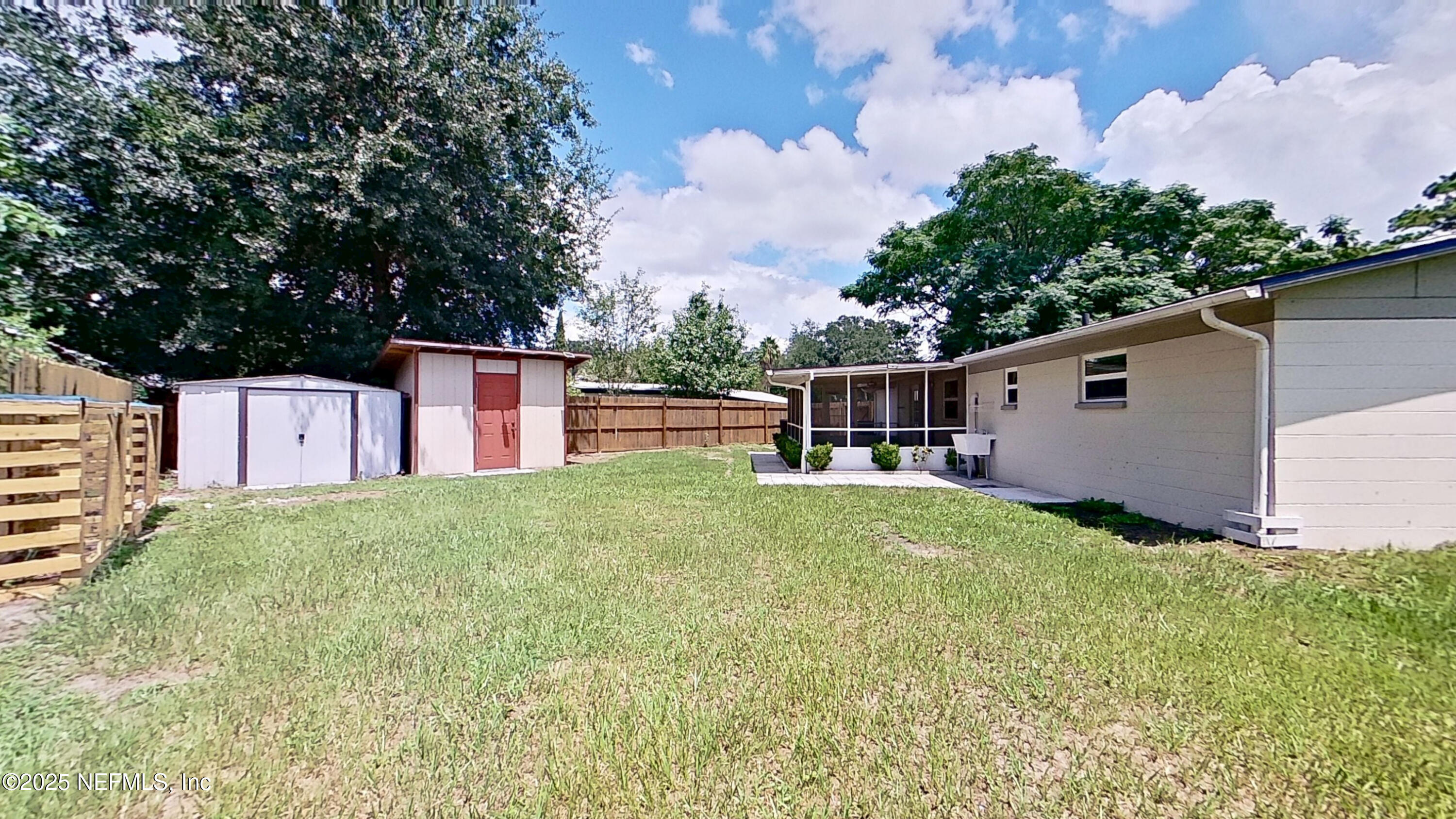 399 Toccoa Road Orange Park, FL 32073 - Photo 25 of 31 a backyard of a house with plants and barbeque oven