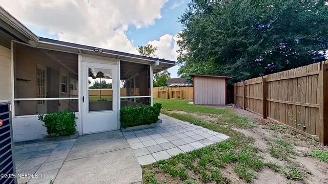 a view of a backyard with potted plants