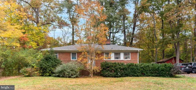 a front view of a house with a yard and potted plants