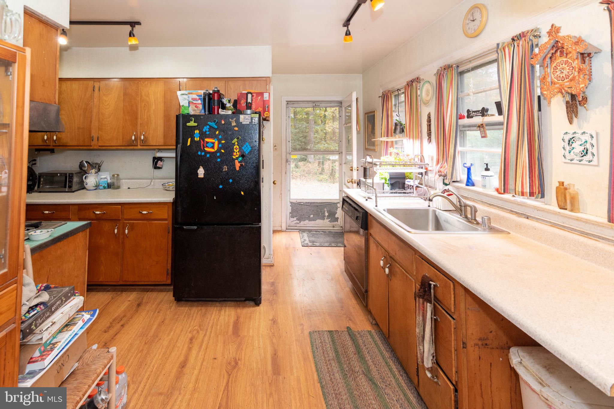 3270 Woodcox Road Indian Head, MD 20640 - Photo 11 of 49 a kitchen with stainless steel appliances granite countertop a refrigerator a sink dishwasher a stove and white countertops with wooden floor