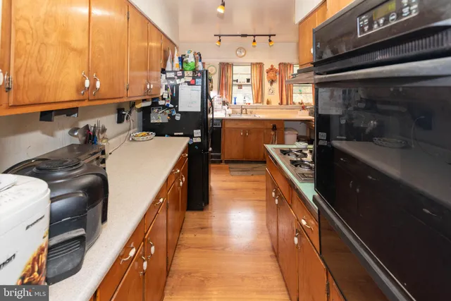a kitchen with a sink a stove and cabinets