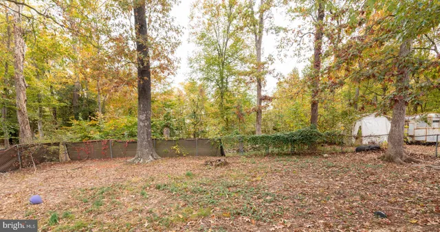 a view of a backyard with table and chairs and a fire pit