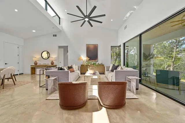 a living room with couches and a coffee table with garden view