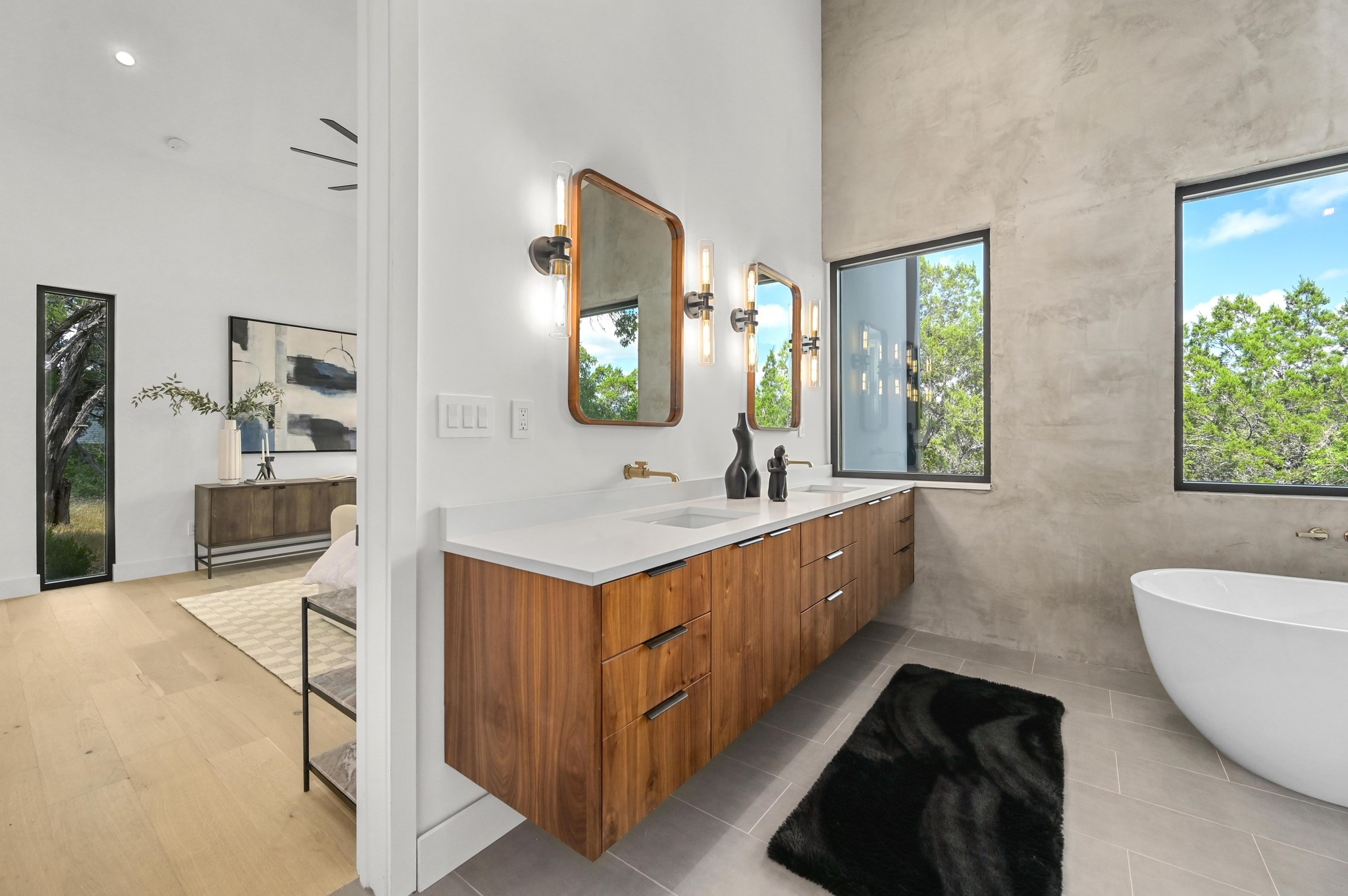 18845 Hidden Ridge Place Jonestown, TX 78645 - Photo 17 of 36 a bathroom with a double vanity sink a mirror and a bathtub