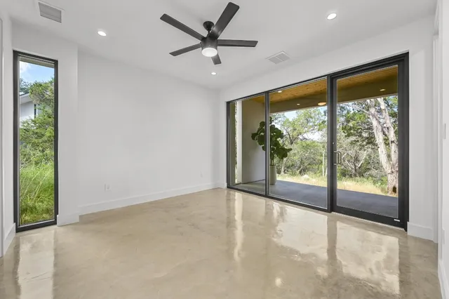 a view of a livingroom with a ceiling fan and window