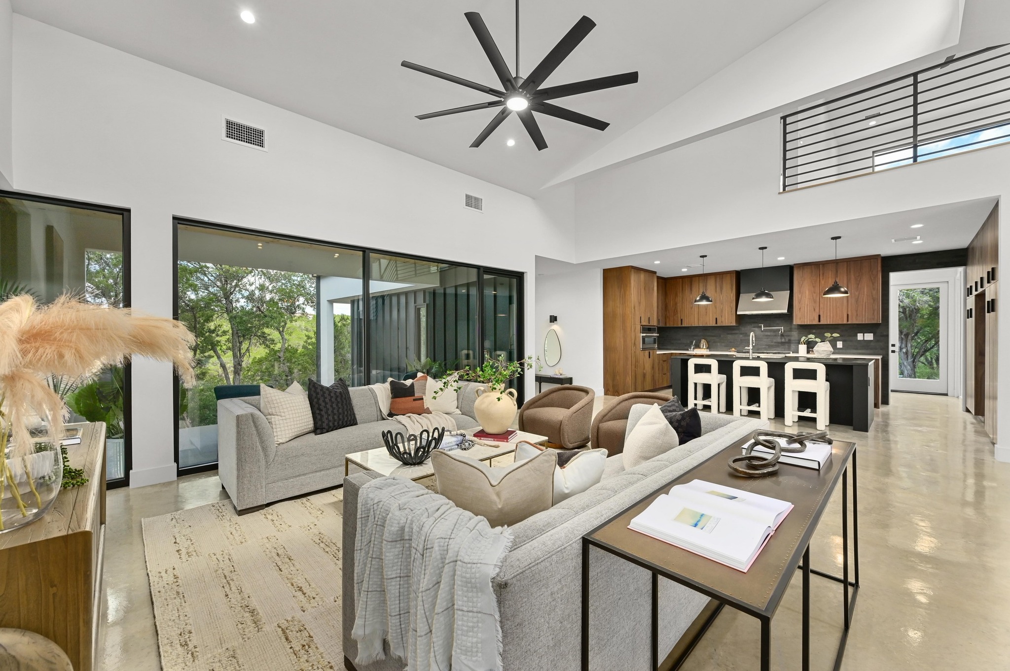 18845 Hidden Ridge Place Jonestown, TX 78645 - Photo 8 of 36 a living room with furniture potted plant and a large window