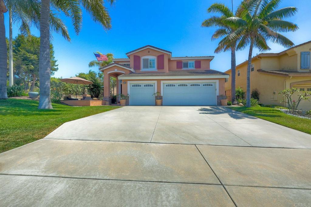 6738 Solandra Drive Carlsbad, CA 92011 - Photo 2 of 11 a front view of a house with a yard and garage
