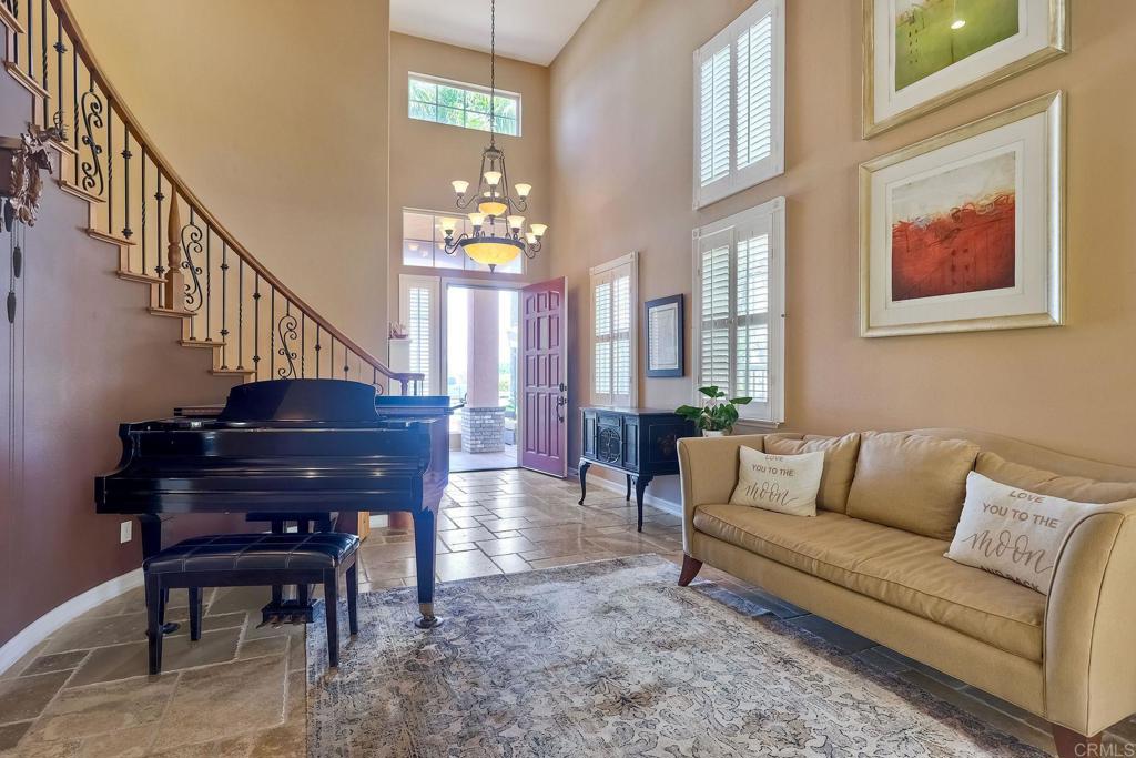 6738 Solandra Drive Carlsbad, CA 92011 - Photo 6 of 11 a living room with furniture a piano and a piano