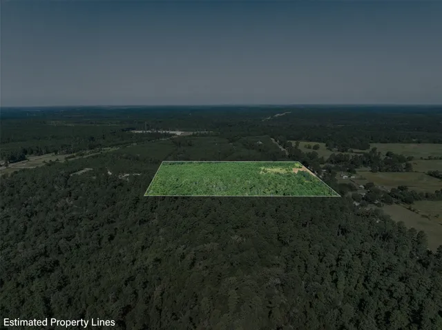 a view of a green field with lots of bushes
