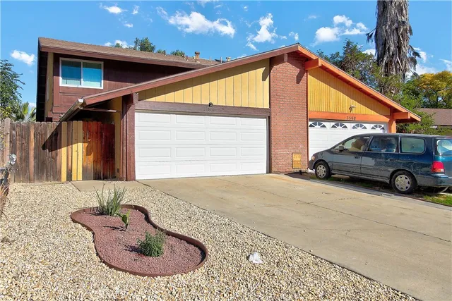 a view of a car park in front of a house