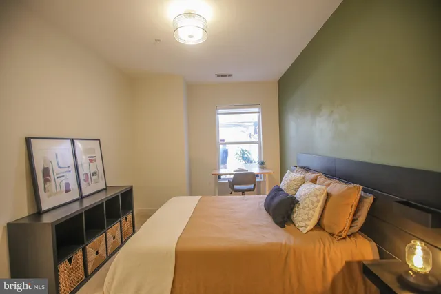 a bedroom with a bed and a window