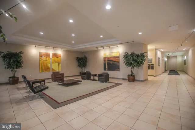 a lobby with furniture and potted plants
