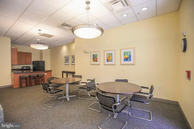 a view of a dining room with furniture and a chandelier
