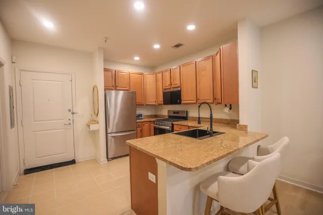 a kitchen with a refrigerator a sink and a refrigerator