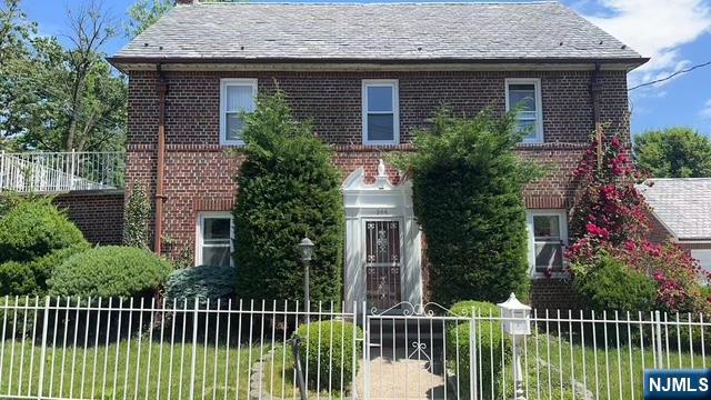 a view of a house with iron fence