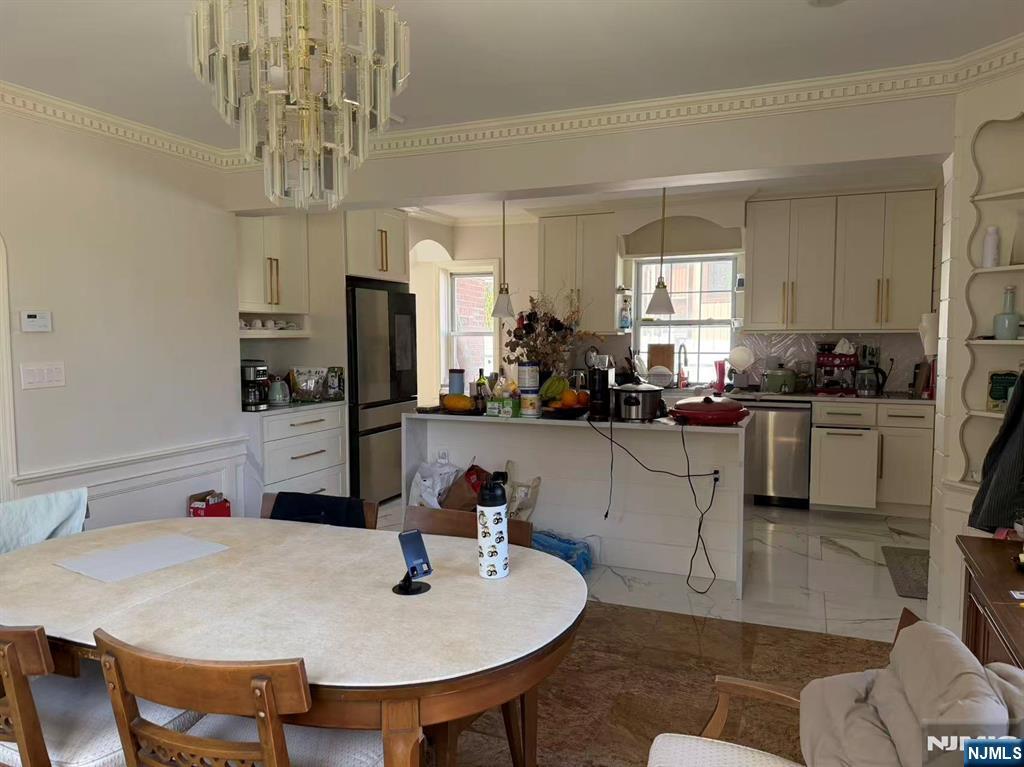 255 Bluff Road Fort Lee, NJ 07024 - Photo 6 of 14 a open dining room with stainless steel appliances kitchen island granite countertop furniture and a kitchen view