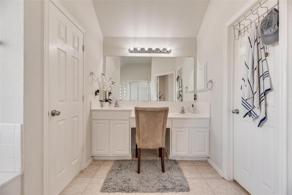 6810 Amesbury Lane Rowlett, TX 75089 - Photo 14 of 22 a bathroom with a sink and a mirror