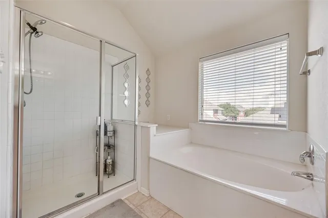 a bathroom with a bathtub and a shower