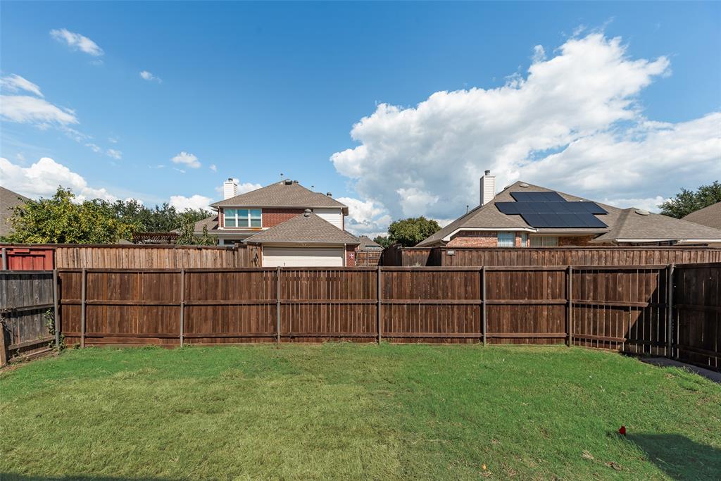 6810 Amesbury Lane Rowlett, TX 75089 - Photo 18 of 22 a view of a backyard with a garden