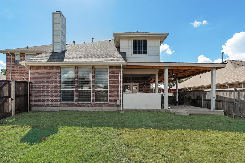 6810 Amesbury Lane Rowlett, TX 75089 - Photo 19 of 22 a view of a house with a yard and sitting area