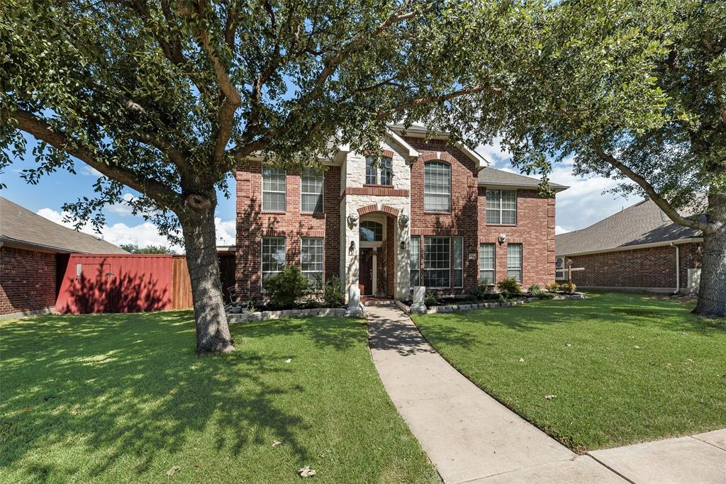 6810 Amesbury Lane Rowlett, TX 75089 - Photo 20 of 22 a front view of house with yard and green space