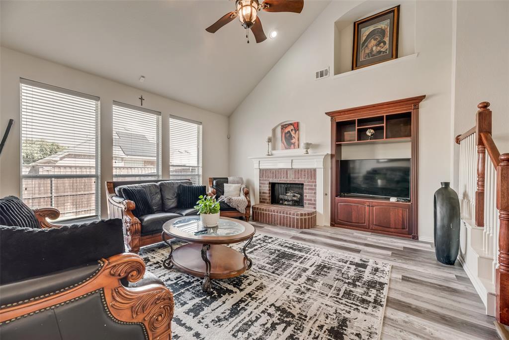 6810 Amesbury Lane Rowlett, TX 75089 - Photo 6 of 22 a living room with furniture a window and a fireplace