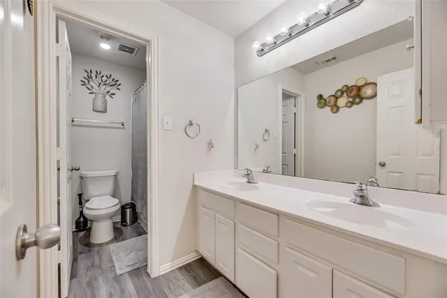 a bathroom with a double vanity sink and mirror