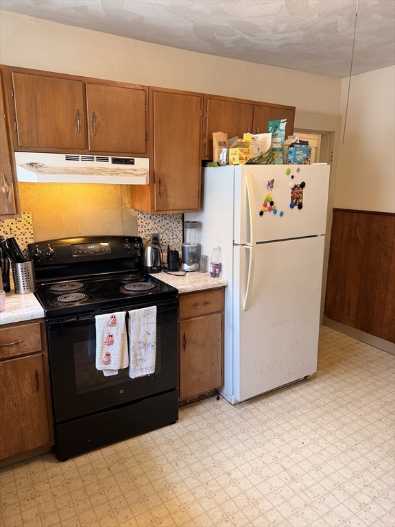 49 Sunset Road, Unit 49 Somerville, MA 02144 - Photo 13 of 24 a kitchen with a refrigerator and a stove