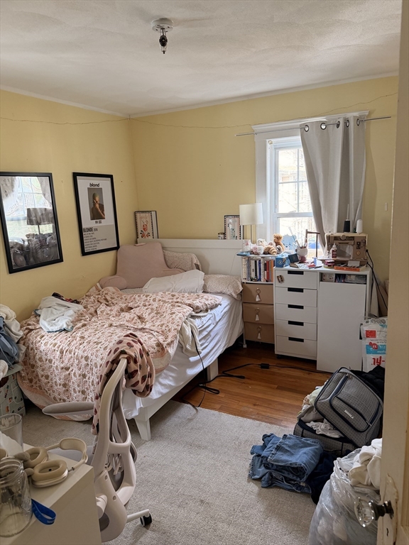 49 Sunset Road, Unit 49 Somerville, MA 02144 - Photo 16 of 24 a bedroom with a bed and furniture
