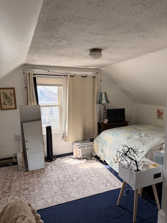 49 Sunset Road, Unit 49 Somerville, MA 02144 - Photo 17 of 24 a bedroom with a bed and wooden floor