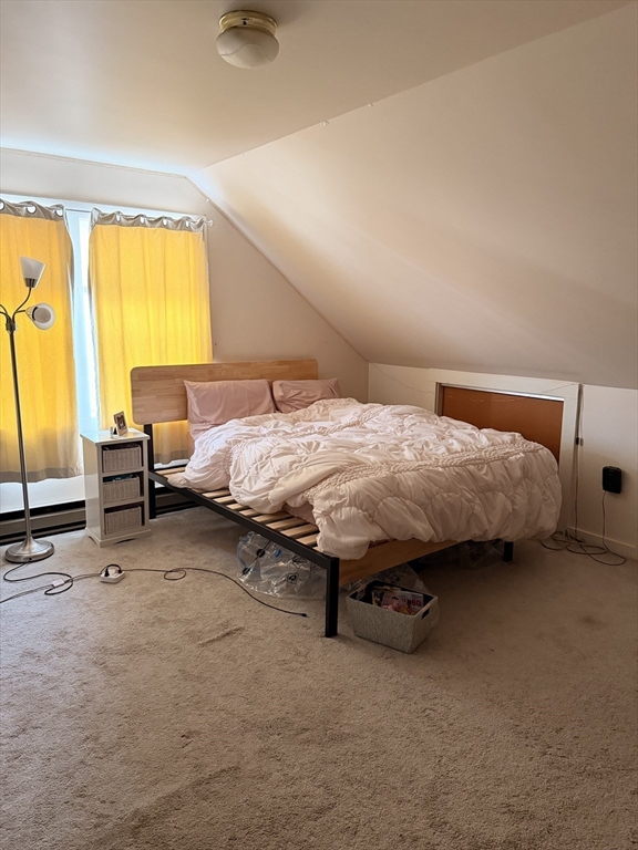 49 Sunset Road, Unit 49 Somerville, MA 02144 - Photo 20 of 24 a bed sitting in a room next to a window