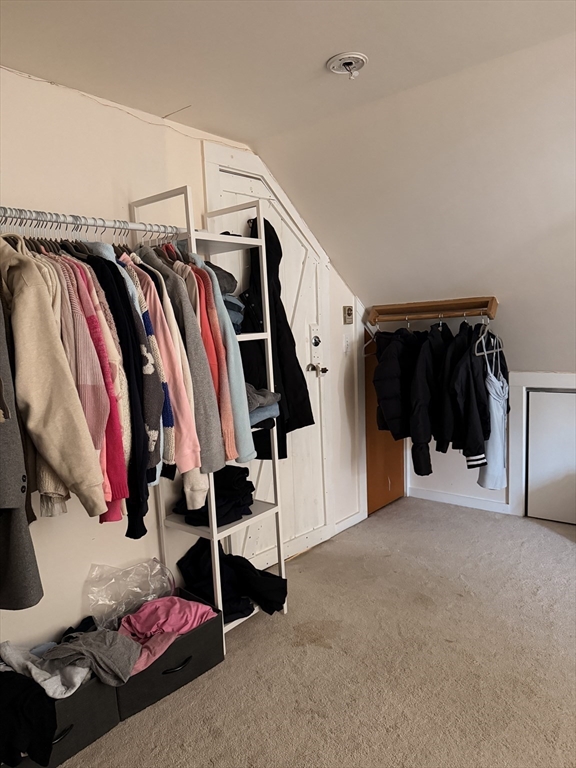 49 Sunset Road, Unit 49 Somerville, MA 02144 - Photo 22 of 24 a view of walk in closet with clothes and shoes