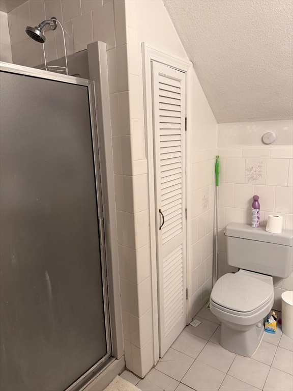 49 Sunset Road, Unit 49 Somerville, MA 02144 - Photo 23 of 24 a white toilet sitting next to a bathroom sink