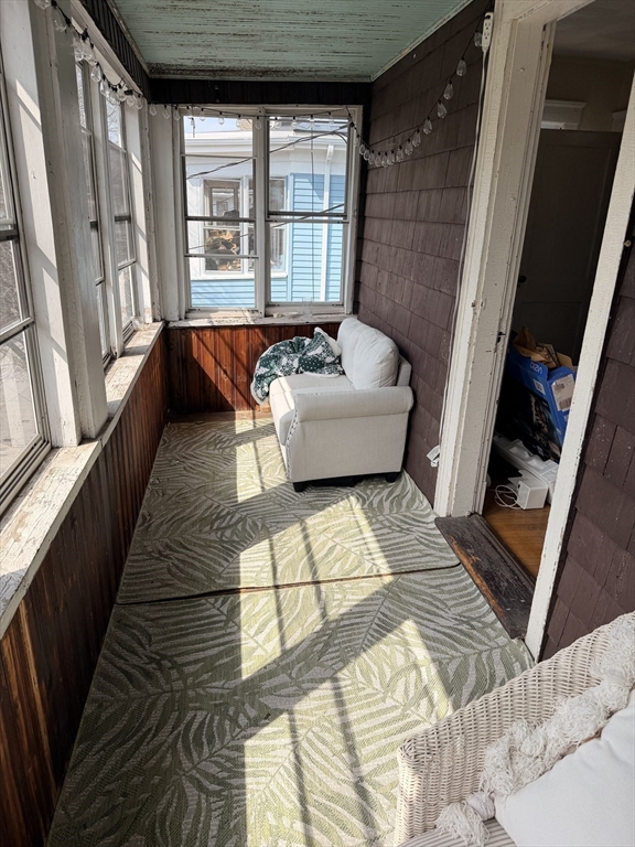 49 Sunset Road, Unit 49 Somerville, MA 02144 - Photo 5 of 24 a living room with furniture and a floor to ceiling window