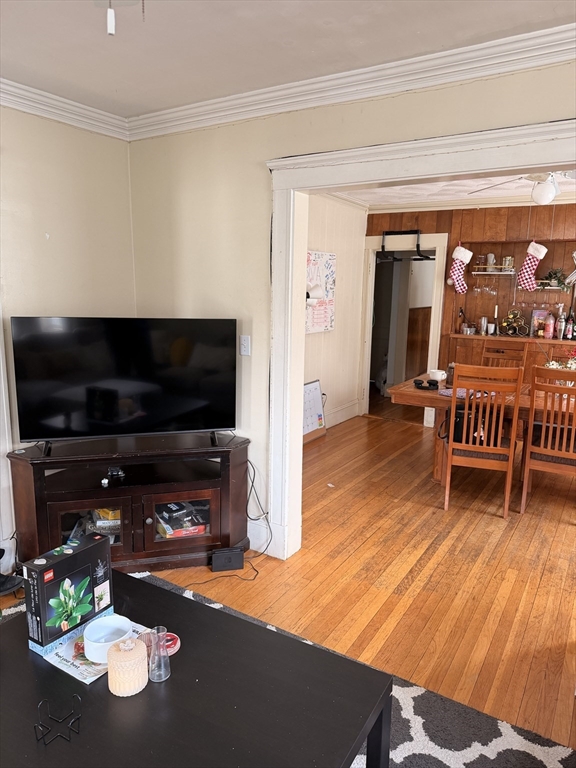 49 Sunset Road, Unit 49 Somerville, MA 02144 - Photo 6 of 24 a living room with furniture and a flat screen tv