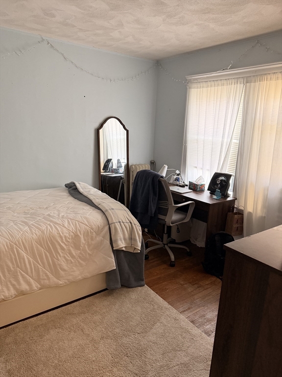 49 Sunset Road, Unit 49 Somerville, MA 02144 - Photo 10 of 24 a bedroom with a bed and a windows