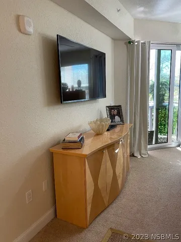 a backyard of a house with barbeque oven table and chairs