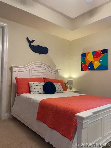 a dining room with wooden floor a chandelier a wooden table and chairs